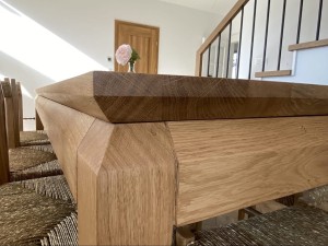 Stół Ninli z litego drewna dębowego – elegancki blat i oskrzynia z możliwością wyboru charakterystycznego wcięcia. Luksusowy stół premium do jadalni i przestrzeni designerskich.